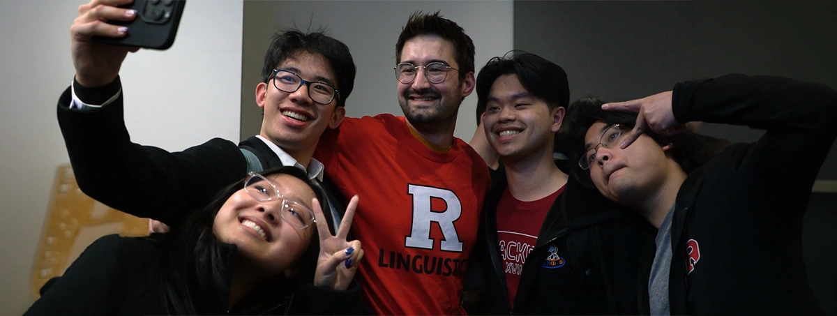 The selected region shows a person wearing a bright red Rutgers University sweatshirt with a large white "R" logo and the word "LINGUISTICS" printed across the front.